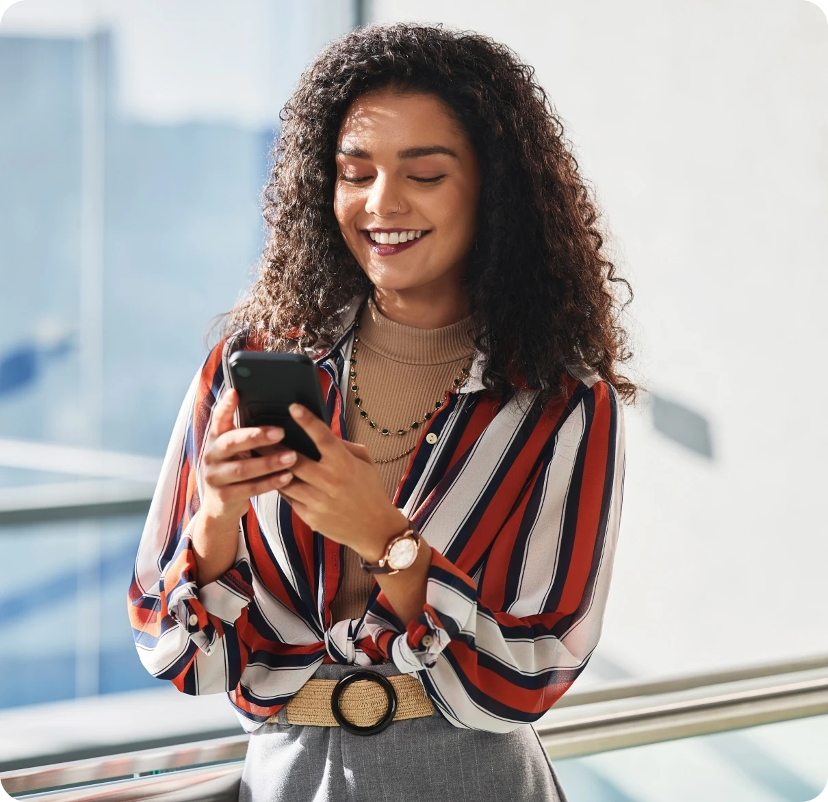 Person using phone with striped shirt